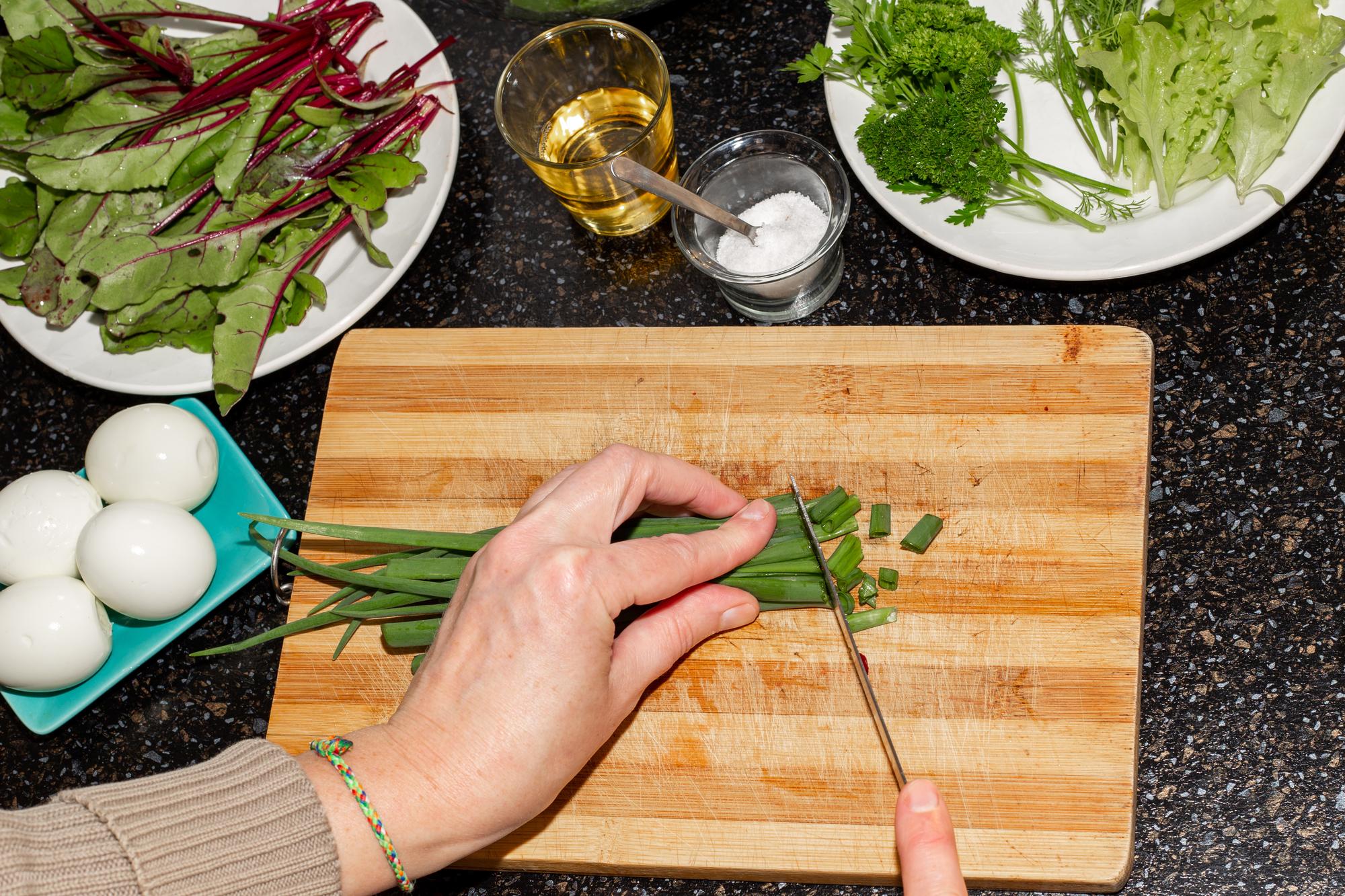 chef arranging herbs on a wooden counter