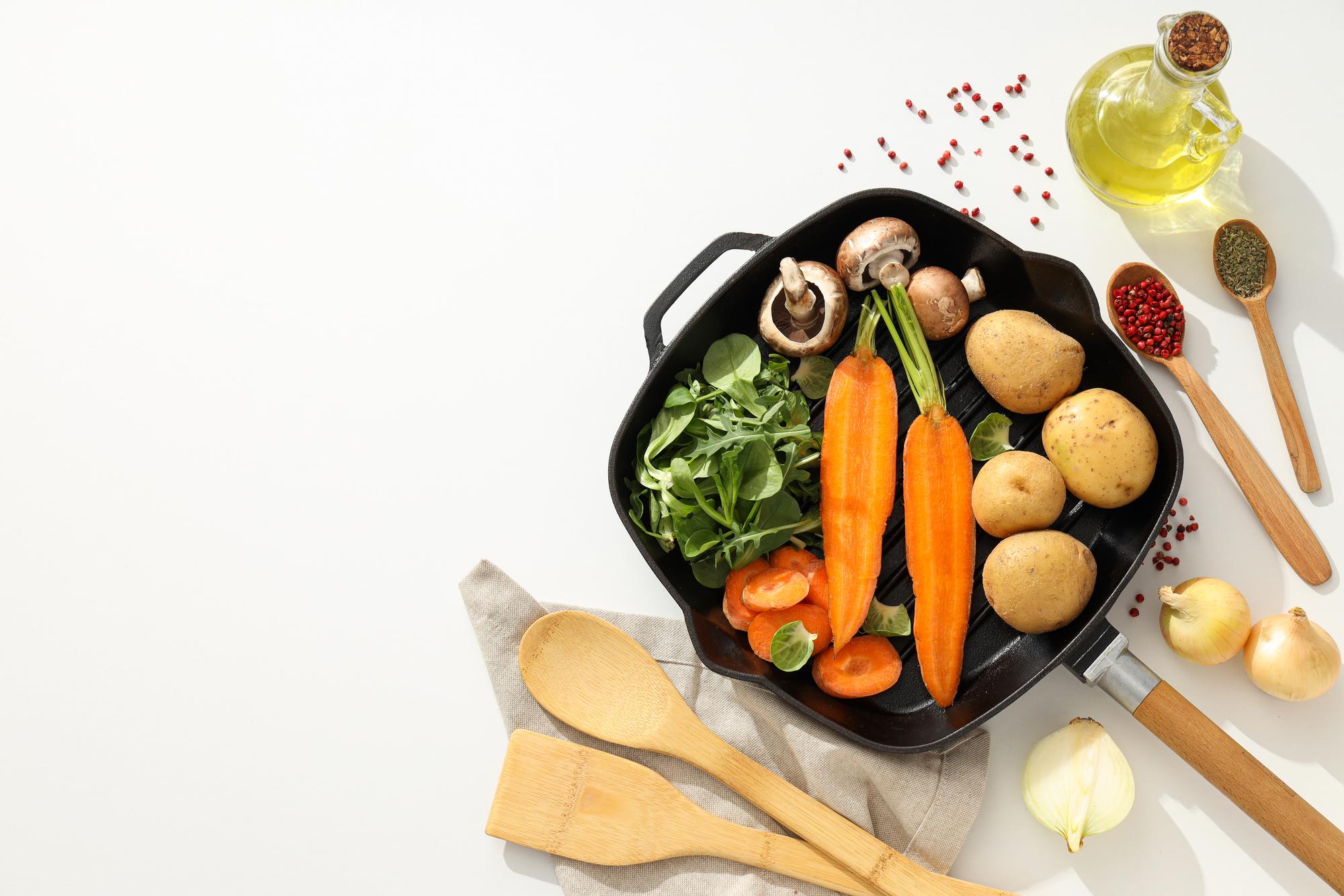 close-up: pan searing vegetables with herbs